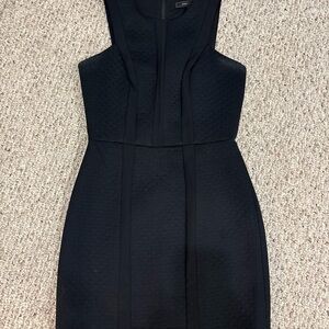 BCBG Max Azria Avina black cocktail dress with a subtle quilted pattern.